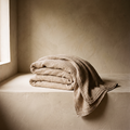 Oversized oatmeal gauze bed throw, folded