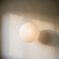 Round paper lantern pendant light, lit