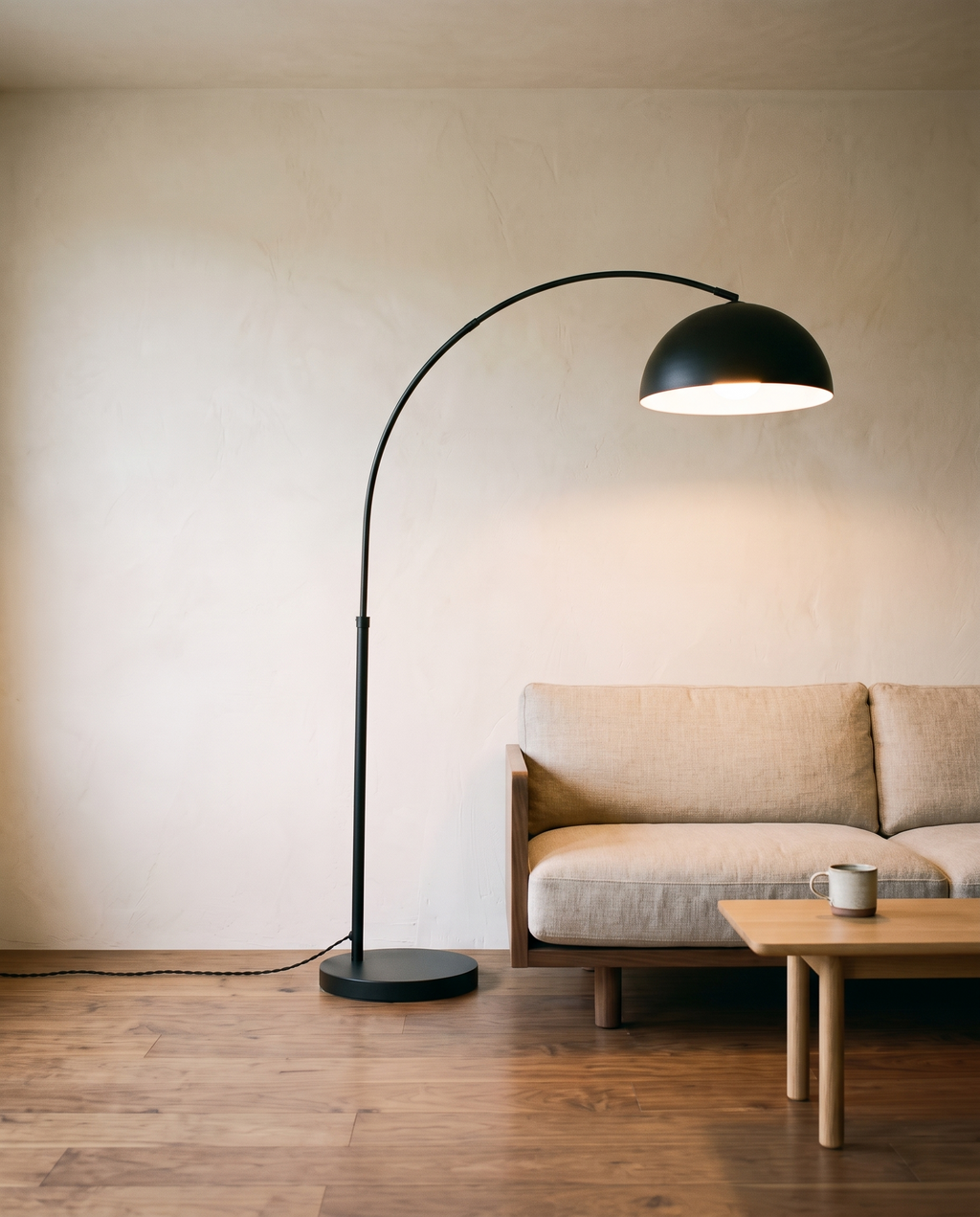 Arc floor lamp over a linen sofa